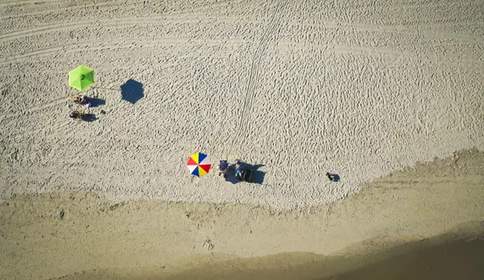Overhead shot of two umbrellas on a beach