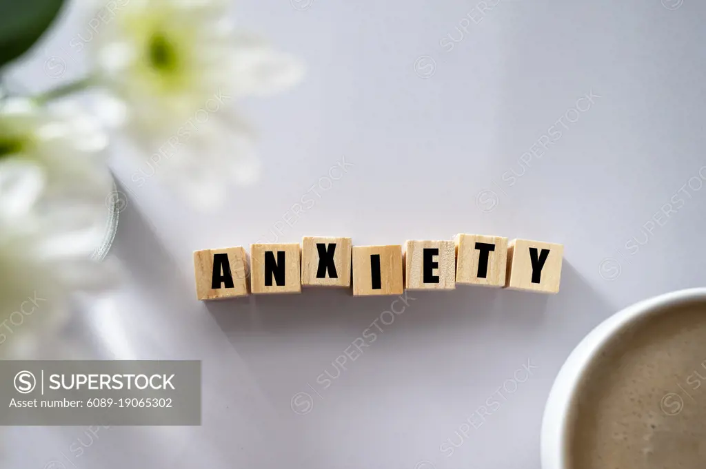 Wooden block with word ANXIETY. Mental health concept