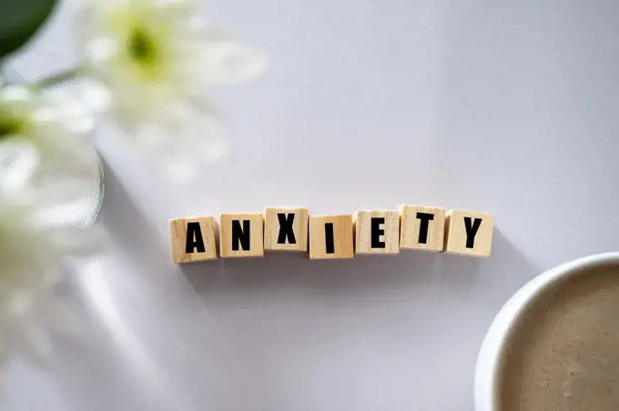 Wooden block with word ANXIETY. Mental health concept
