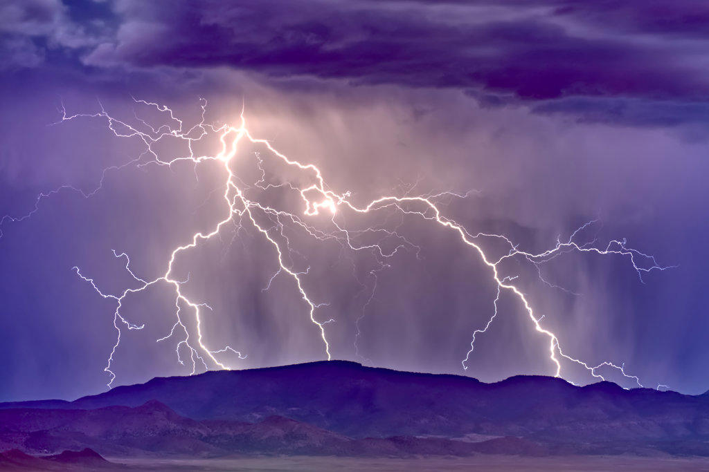 A lightning storm building behind Woodchute Mountain just east of Chino Valley Arizona during the 2022 Monsoon season.