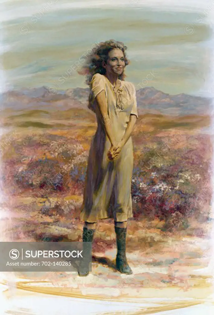Woman standing in a field and smiling