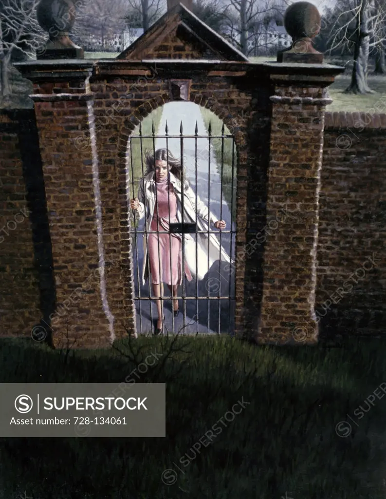 Woman standing behind an iron gate