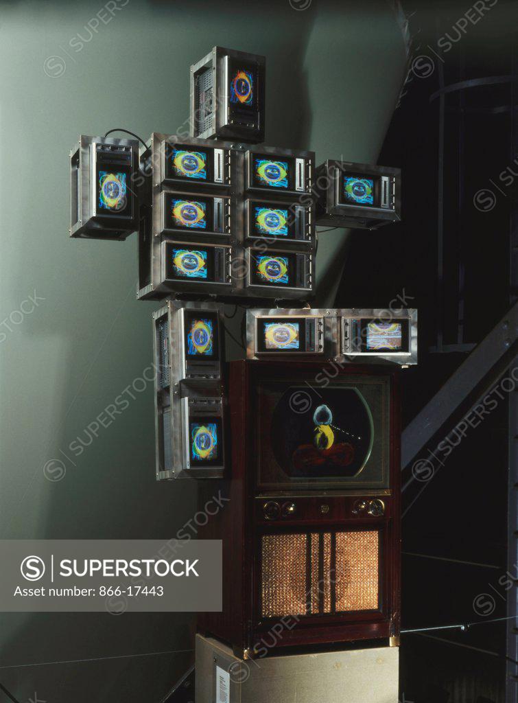 Stock Photo: 866-17443 High Tech Baby. Nam June Paik (1932-2006). 13 colour TV sets, aluminium framework, TV cabinet screen, acrylic paint, videodisc and player. Executed in 1986. 203 x 108 x 51cm.