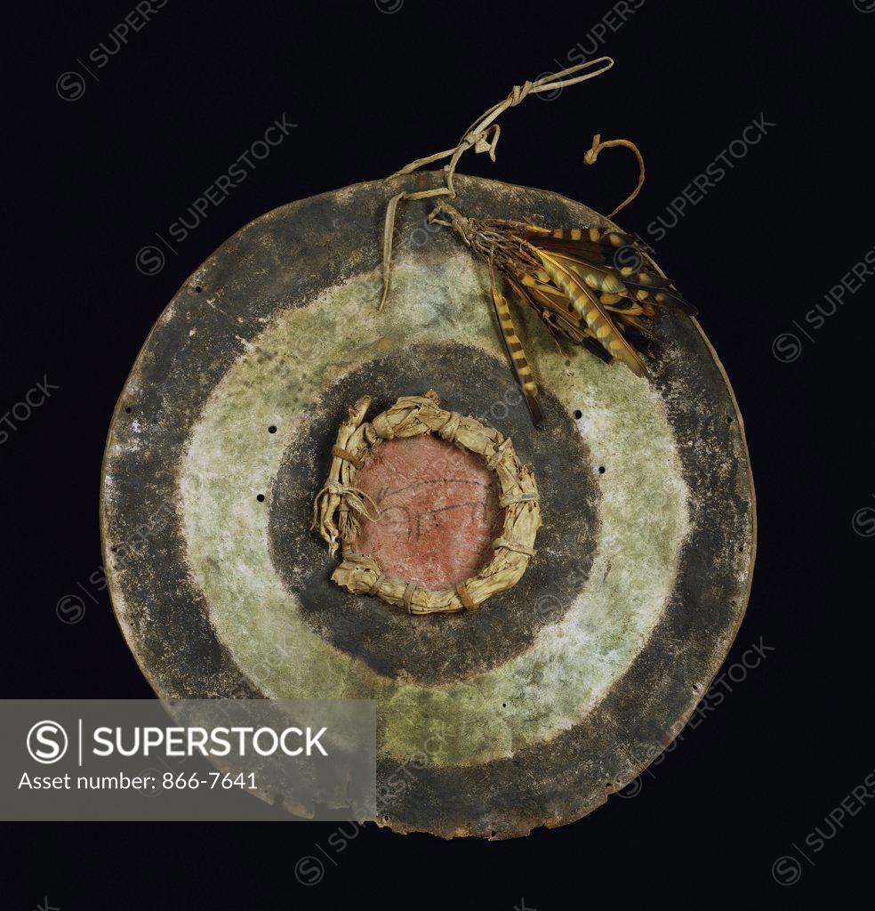 Stock Photo: 866-7641 Arapaho painted hide shield, with yellow and brown striped feathers attached at the top. American Indian, 47.7cm diam.