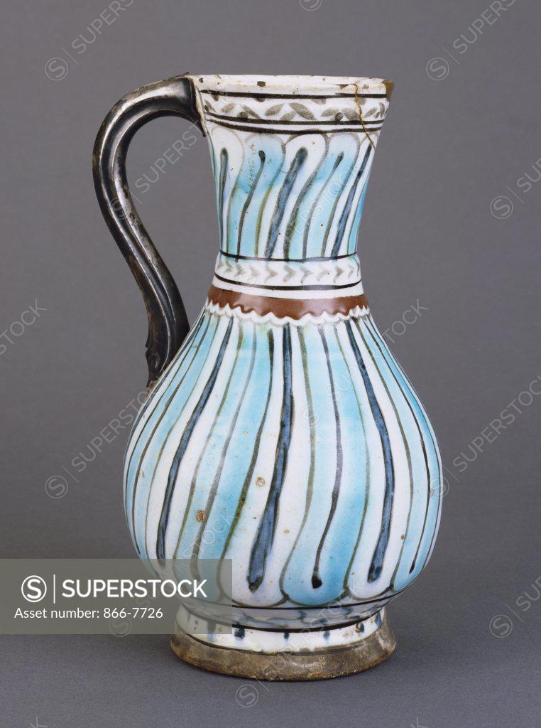 Stock Photo: 866-7726 An Iznik pottery jug, the white ground painted with turquoise and dark blue stripes outlined in black. 25.5cm high.