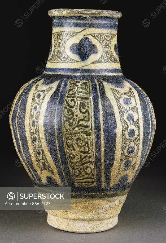 Stock Photo: 866-7727 A fine Syrian pottery baluster vase. The white exterior painted under the glaze with vertical panels of black inscriptions. Damascus, 14th century, 31.7cm high.
