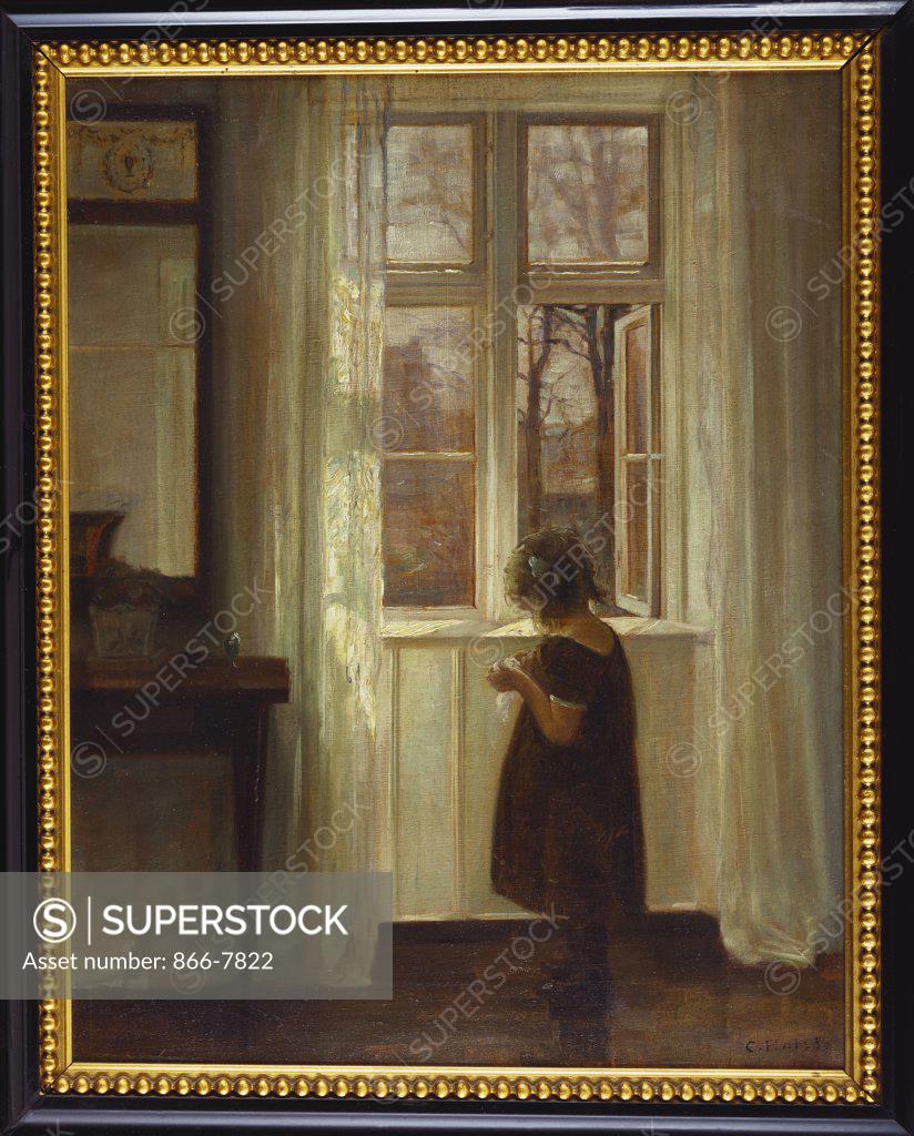 Stock Photo: 866-7822 A Girl Standing at a Window. Carl Holsoe (1863-1935). Oil on canvas, 55.2 x 43.8cm.