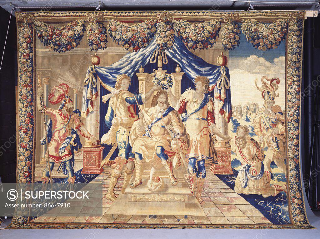 Stock Photo: 866-7910 A Brussels historical tapestry, woven in wools and silks, depicting an enthroned King under a canopy, being crowned with a laurel wreath by two courtiers. Late 17th century. 377cm x 480cm.
