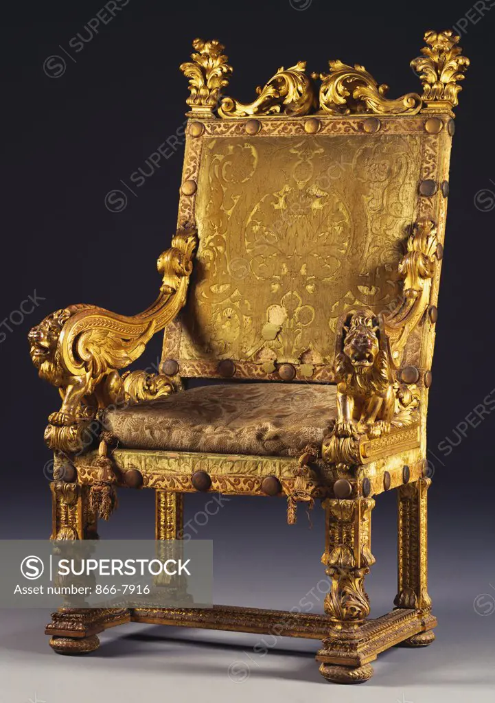 An Italian giltwood open armchair of 17th century style, with padded back and seat covered in green-cut velvet. 19th century.
