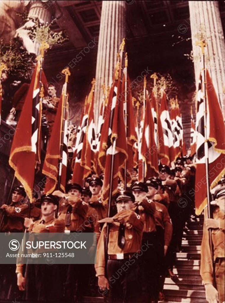 Stock Photo: 911-125548 Army soldiers carrying Nazi flags in a parade