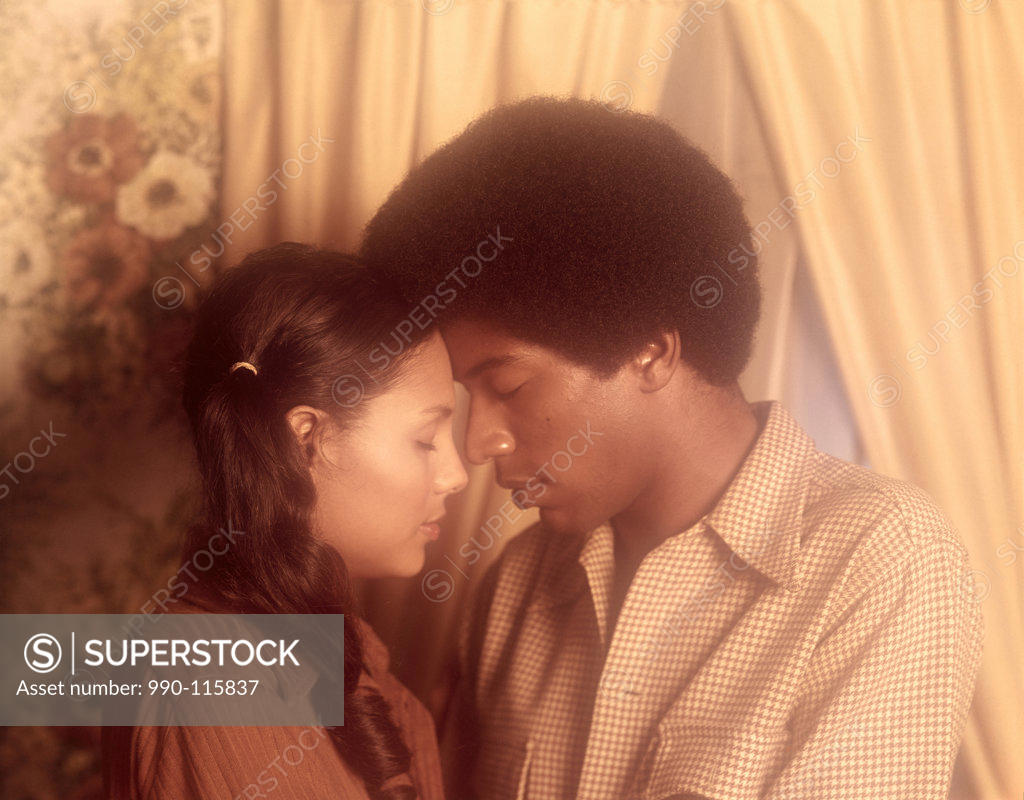 Stock Photo: 990-115837 Side profile of a young couple touching