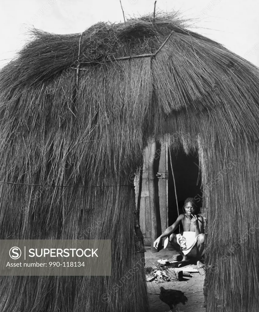 Man squatting in a hut, Brazzaville, Republic of the Congo