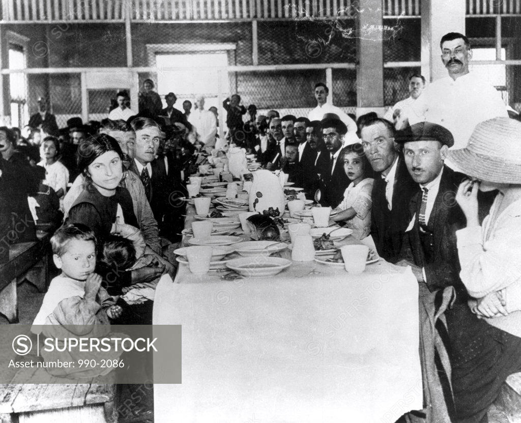 Stock Photo: 990-2086 Immigrants at a dining table, Ellis Island, New York City, New York, USA