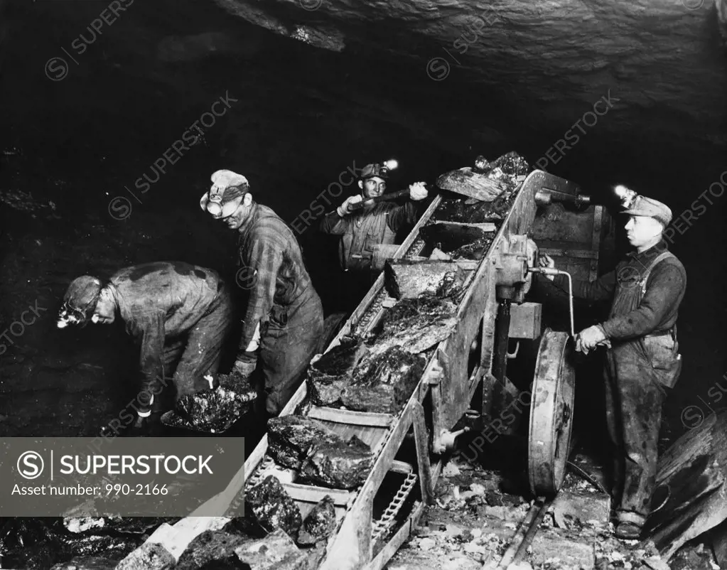 High angle view of four miners working in a pit mine, Pennsylvania, USA