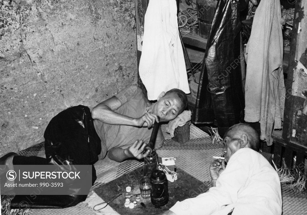 Stock Photo: 990-3593 China, Hong Kong, High angle view of two mature men smoking opium